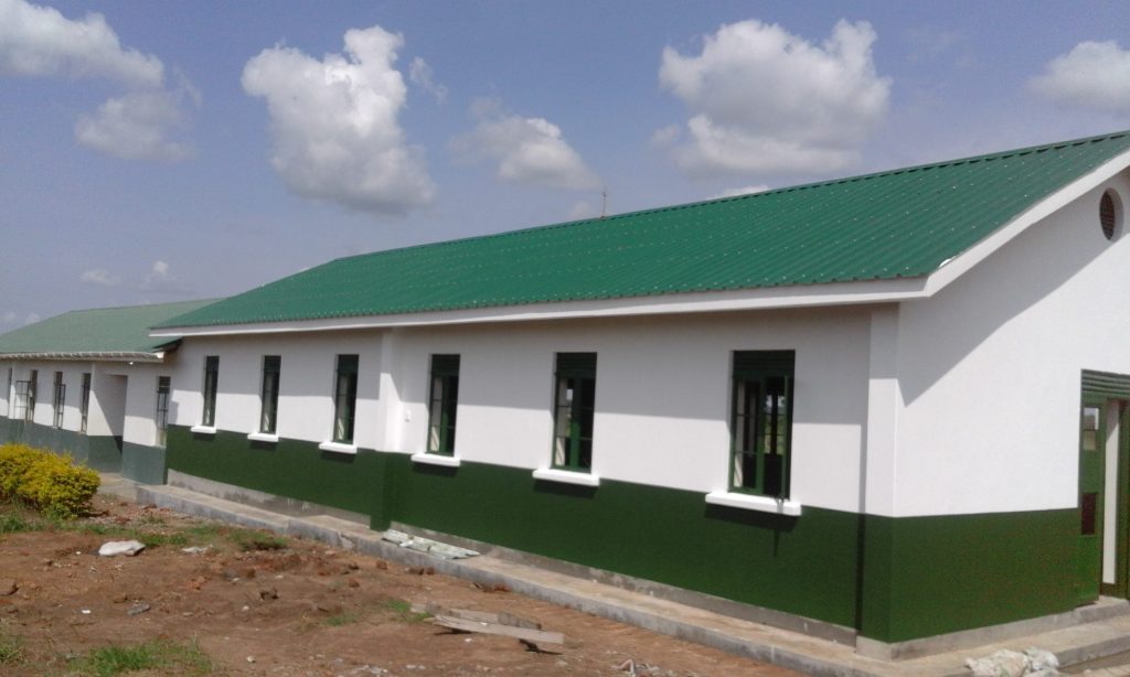 Completed dormitory block with a green roof