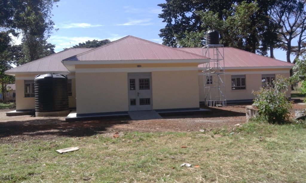 Completed single-storey health facility with a water tank