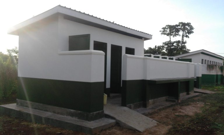 Completed latrine block painted white and green