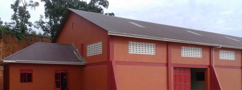 Completed warehouse with red walls and a grey iron roof